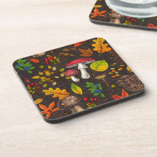 Autumn mushrooms, leaves, nuts and berries on dark coaster