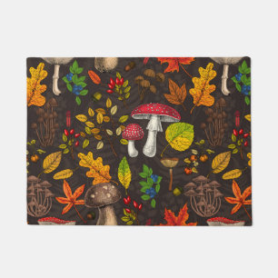 Autumn mushrooms, leaves, nuts and berries on dark doormat