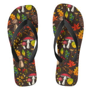 Autumn mushrooms, leaves, nuts and berries on dark flip flops