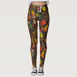 Autumn mushrooms, leaves, nuts and berries on dark leggings