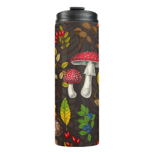 Autumn mushrooms, leaves, nuts and berries on dark thermal tumbler