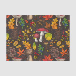 Autumn mushrooms, leaves, nuts and berries on dark tissue paper