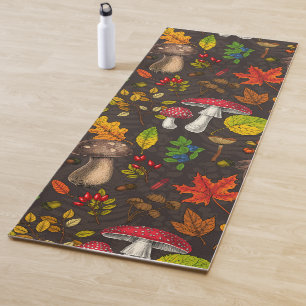 Autumn mushrooms, leaves, nuts and berries on dark yoga mat