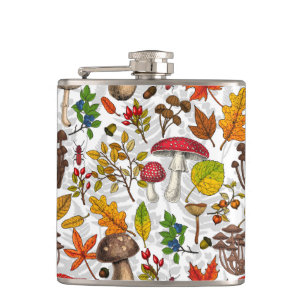 Autumn mushrooms, leaves, nuts and berries on whit hip flask