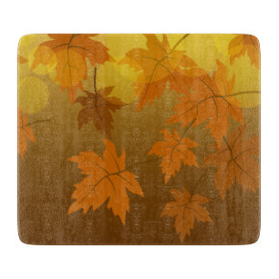 Autumn pattern with falling maple leaves and bokeh cutting board