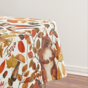 Autumn squirrels and autumnal flora on off white tablecloth