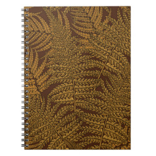 Autumnal fern on brown notebook