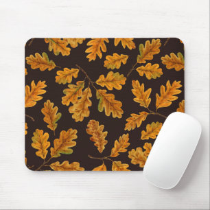 Autumnal oak leaves on dark brown mouse mat