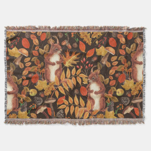 Autumnal squirrels and flora on dark brown throw blanket