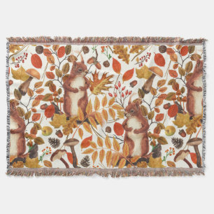 Autumnal squirrels and flora on dark brown throw blanket