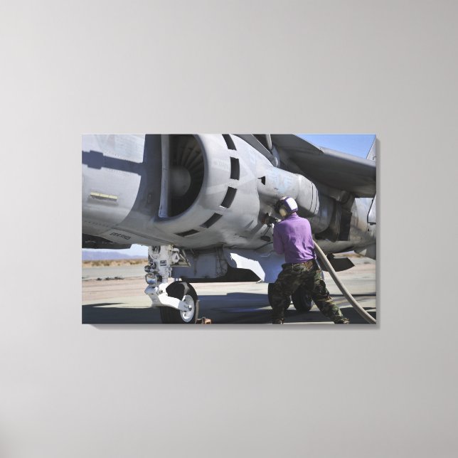 Aviation fuel technician attaches a fuel line canvas print (Front)
