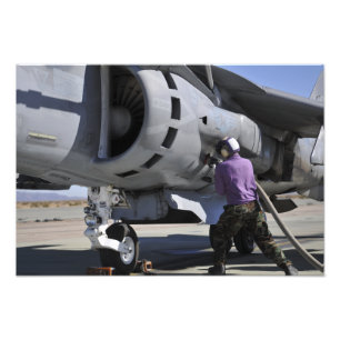Aviation fuel technician attaches a fuel line photo print
