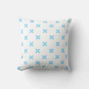 Baby blue cross stitches on white cushion