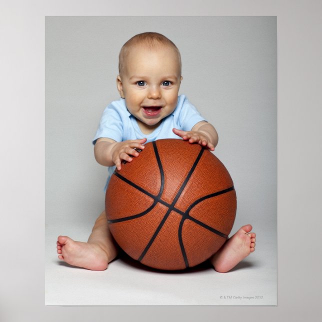 Baby boy (6-9 months) holding basketball, poster (Front)