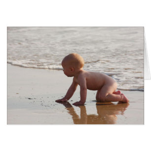 Baby playing in the sand on the beach
