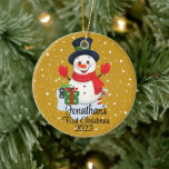 Baby's First Christmas cute snowman black hat  Ceramic Tree Decoration<br><div class="desc">A whimsical Christmas tree ornament featuring an adorable snowman surrounded by delicate snowflakes. Customise it with your child's name and the year for a personalised touch that captures the joy of the season.
Use the "Personalise" button to customise to your liking.</div>