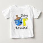 Baby's First Hanukkah Baby T-Shirt<br><div class="desc">Baby's First Hanukkah cute design featuring a cartoon dreidel. Celebrate a Jewish boy or girl's 1st Hanukkah with this cute,  baby and newborn design. Great for any Jewish newborn!</div>