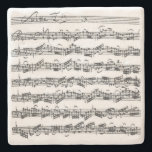 Bach Cello Suite Music Manuscript Stone Coaster<br><div class="desc">The first page from J.S. Bach's second Suite for cello solo is displayed on this natural stone coaster, reproduced from Anna Magdalena Bach's handwritten copy. When not doing service on the counter or table, this item is simply a lovely object to have on view in a cellist's home or studio;...</div>
