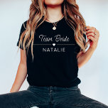 Bachelorette Party Team Bride Personalised Bridal T-Shirt<br><div class="desc">Elevate your bachelorette party style with our Team Bride Personalised Bridal T-Shirt in a chic and bold dark colour, adorned with striking white prints. Designed for the bride and her squad, these dark-coloured shirts add a touch of sophistication to your celebration while maintaining a sense of fun and unity. The...</div>