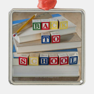 Back to school building blocks on stacked books metal tree decoration