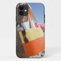 Bag Hanging On Tree Trunk At Sandy Beach