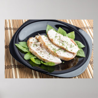 Baked slices of chicken meat on a black plate poster