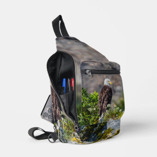 Bald eagle sitting on the rock sling bag