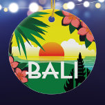 Bali Indonesia memento vintage travel style Ceramic Tree Decoration<br><div class="desc">Bali Indonesia ornament with an original collage illustration modelled after the vintage travel style posters of the past. The brightly coloured tropical image includes a sunset over the ocean, a stylised palm tree, frangipani flowers, and a silhouette of a Balinese temple. The ornament makes a wonderful memento of a visit...</div>