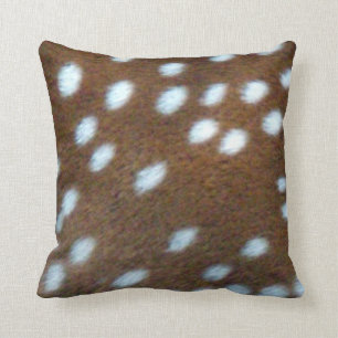 Bambi white spots on a brown fur cushion