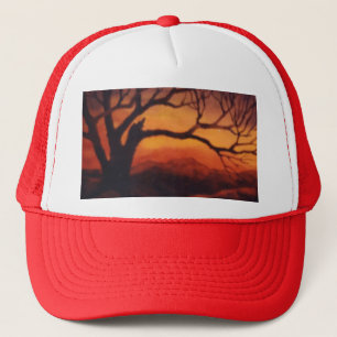 Bare limbed dead tree in front of sunset trucker hat