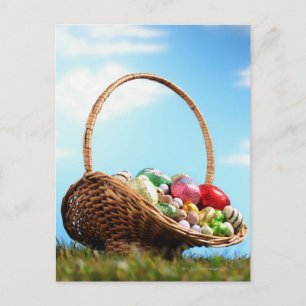 Basketball filled with Easter eggs on grass, groun Holiday Postcard