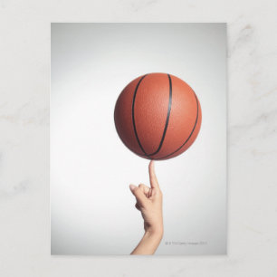 Basketball on index finger,hands close-up postcard