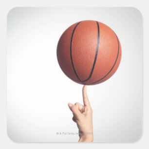 Basketball on index finger,hands close-up square sticker