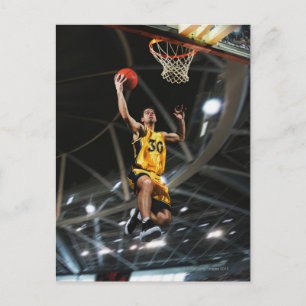 Basketball player  jumping in air postcard