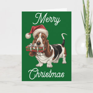 Basset Hound in Santa hat present in mouth Card