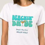 Beach Bachelorette Party Groovy Beachin Bride T-Shirt<br><div class="desc">Make a splash at your upcoming bachelorette party with this stunning beach bachelorette party personalised t-shirts. Whether you're celebrating a bach trip, a girls' vacation, or a best friends' holiday, this custom beach bachelorette party t-shirts are the perfect addition to your unforgettable getaway. Add a personal touch to your bachelorette...</div>