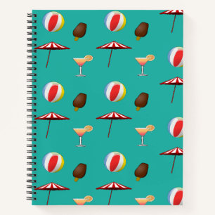 Beach ball, cocktails and ice cream on green notebook