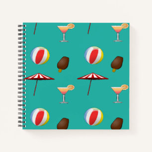 Beach balls, ice cream and cocktail on green notebook