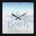 Beach House | Life Is Better At The Beach Square Wall Clock<br><div class="desc">Modern wall clock featuring string lights,  a beach image and personalised with your your family name. The clock would make an gift for anyone who owns a boat or beach house. The fonts style,  size and colour can all be changed by clicking on the customise further link after personalising.</div>