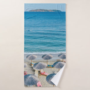 Beach lounge on seashore facing the sea bath towel