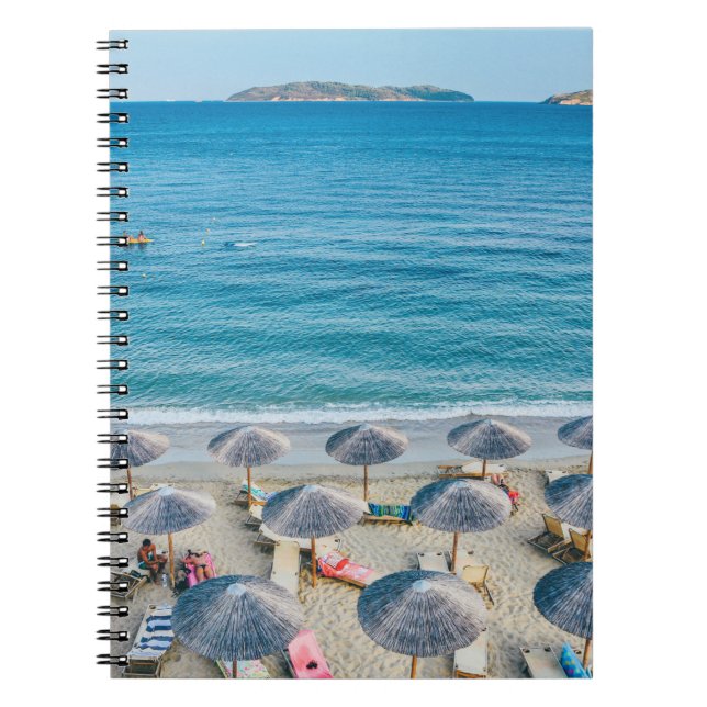 Beach lounge on seashore facing the sea notebook (Front)