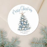 Beach Merry Christmas Classic Round Sticker<br><div class="desc">Celebrate in sunny style with this festive round sticker, perfect for your tropical holiday celebration. A large Christmas tree made of beach shells, starfish, and coral sits in the center, bringing a fun and whimsical coastal vibe to your event. The design features a teal blue and tan color palette that...</div>