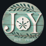 Beach Sand Dollar Christmas Joy Photo Ceramic Orna Classic Round Sticker<br><div class="desc">"Bring the warmth of the beach to your holiday decorations with this rustic JOY sand dollar ornament! Featuring a beautifully crafted sand dollar in place of the 'O' and subtle greenery with red berries, this ornament combines coastal charm with traditional holiday elements. Perfect for beach lovers, this ornament adds a...</div>