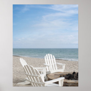 beachfront house with adirondack chairs and poster