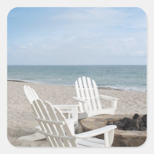 beachfront house with adirondack chairs and square sticker