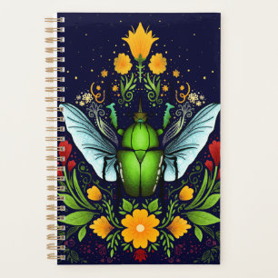 Beatle and flowers on dark blue planner