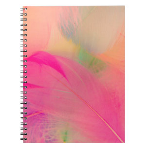 Beautiful abstract purple and blue feathers on whi notebook