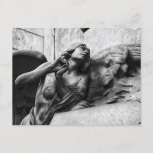 Beautiful angel with serene gaze towards heaven postcard