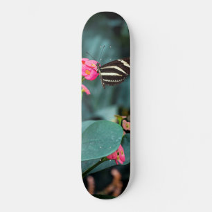 Beautiful butterfly on a pink flower skateboard