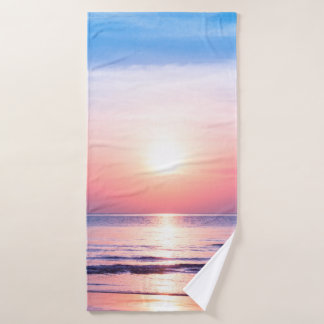 Beautiful morning sunrise, blue sea, pink sky, whi bath towel